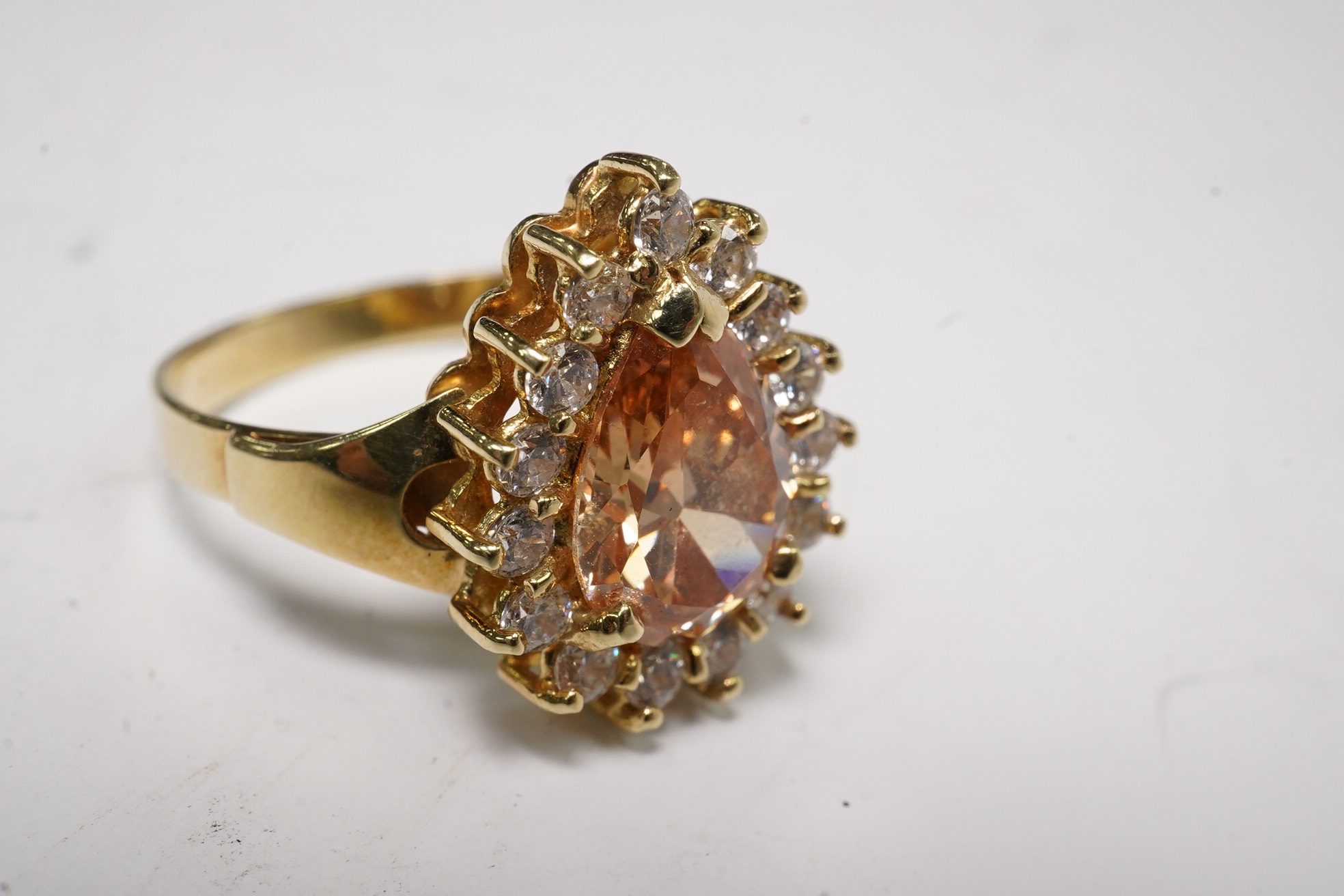 A 14k and simulated diamond set pear shaped cluster ring, size N, gross weight 3.8 grams. Condition - fair to good
